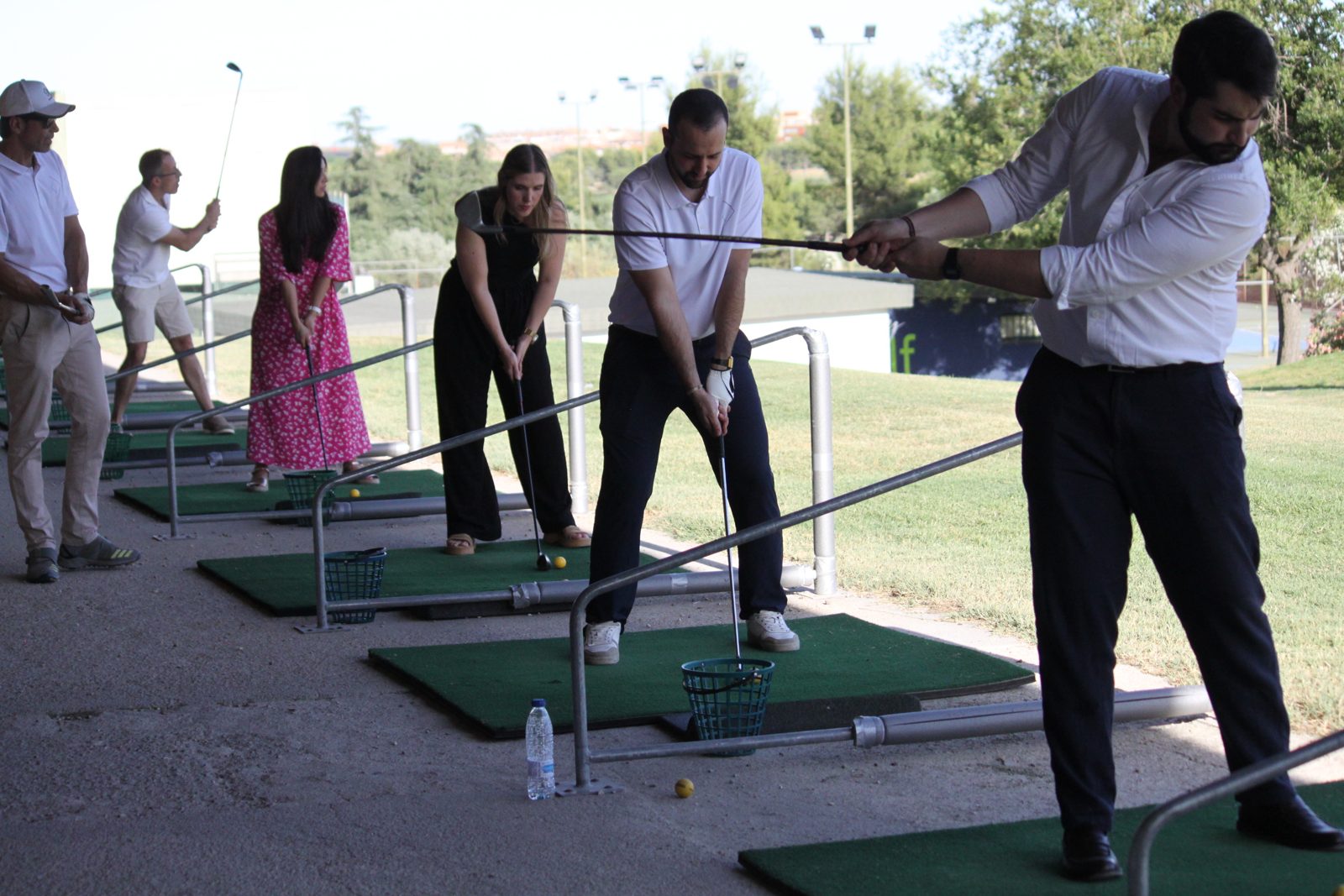 Grupo de asistentes en la zona de práctica de golf